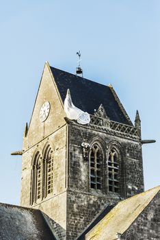 the famous church with the manequin of solder on the tower bell in St Mere Eglise in Normandy