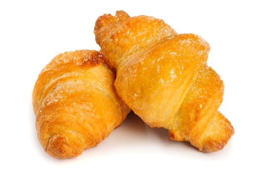 Two fresh just baked croissants on white background, isolated