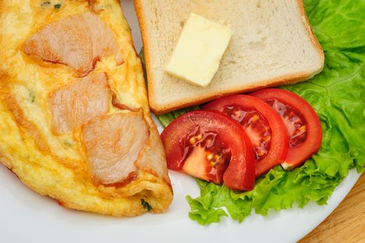 country omelette with bacon, salad and toasts
