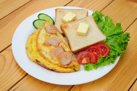 fresh country omelette with bacon, salad and toasts