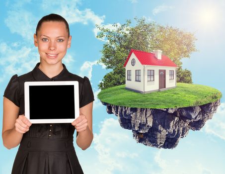Businesswoman with tablet and house on island in the sky with clouds