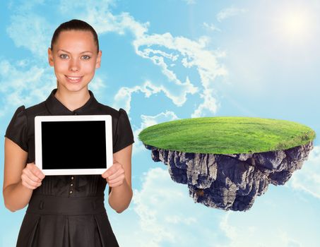 Businesswoman with tablet and island in sky with clouds and green grass