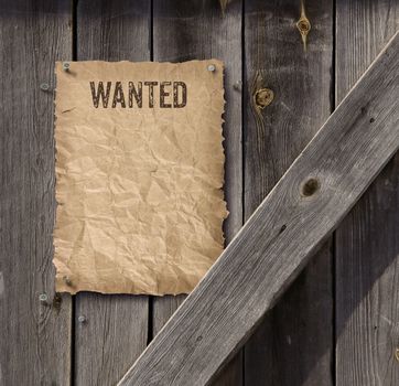 Wild West style wanted poster on weathered plank wood door
