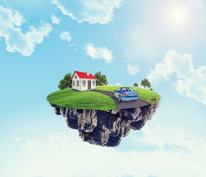 White house with car and road on island in sky with clouds