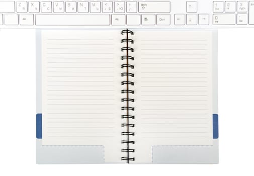 Keyboard and notebook on isolated white background