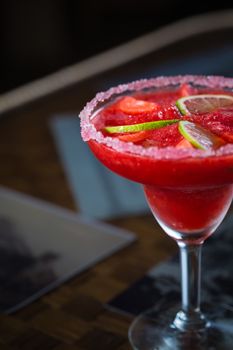 Strawberry margarita cocktail on the bar. Shallow dof