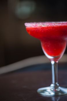 Strawberry margarita cocktail on the bar. Shallow dof