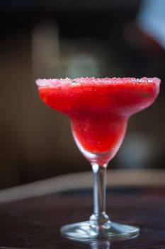 Strawberry margarita cocktail on the bar. Shallow dof