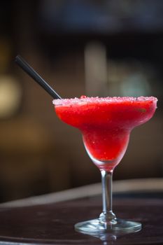 Strawberry margarita cocktail on the bar. Shallow dof