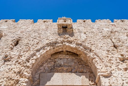 Upper part of Zion Gate, one of the seven gates of the old city of Jerusalem. There are many bullet holes that are clearly seen on the stone