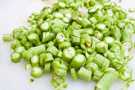 Sliced Green Beans (Phaseolus sp.) on the White Plastic Chopping Board