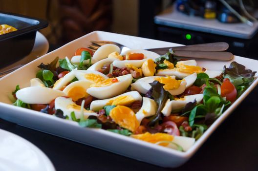 Fresh salad with tomato, lettuce and quail eggs