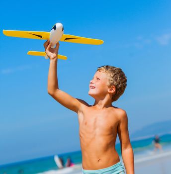 Beach kid boy kite flying outdoor coast ocean