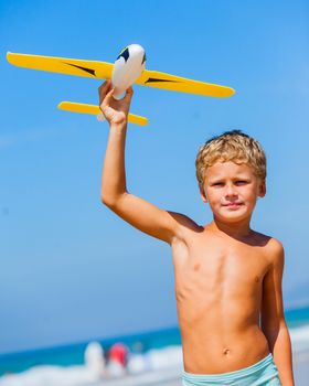 Beach kid boy kite flying outdoor coast ocean