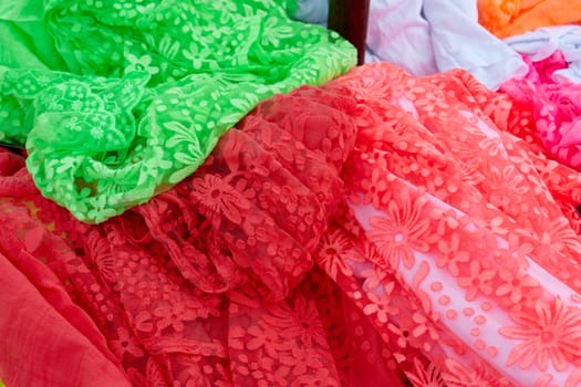 Beautiful colorful scarves hanging  in a fashion accessories shop                                        