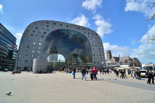 Rotterdam, Netherlands - May 9, 2015: People visit Markthal (Market hall) a new icon in Rotterdam. The covered food market and housing development shaped like a giant arch by Dutch architects MVRDV.