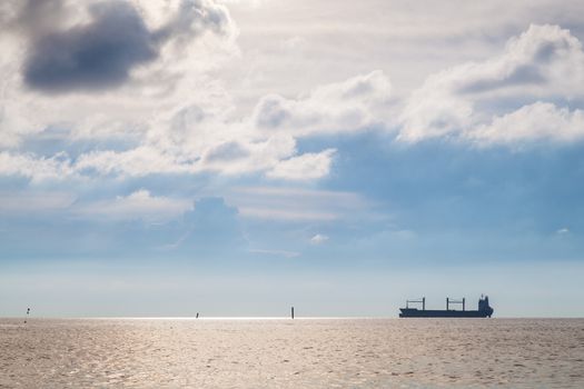 Cargo ship The park is surrounded by the sea. The sky is clear of clouds covered the sun.