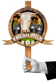 Hand of waiter holding a wooden sign with head of cow, cans of milk, green grass and daisy flowers, wooden ribbon with text Fresh milk. Isolated on white background