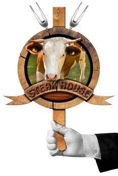 Hand of waiter holding a wooden sign with head of cow, forks and wooden ribbon with text, steak house. Isolated on white background