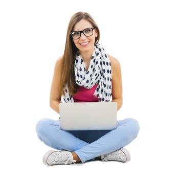 Beautiful woman sitting with crossed legs working with a laptop