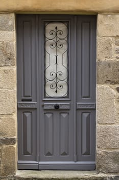 A grey door with decorations in the middle