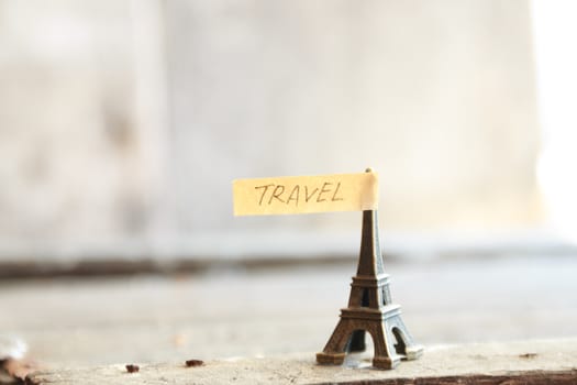 travel concept, Eiffel tower and  inscription "travel", blurred picture for background