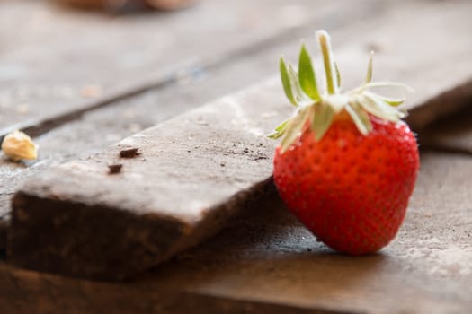 strawberries lying on an old wooden table