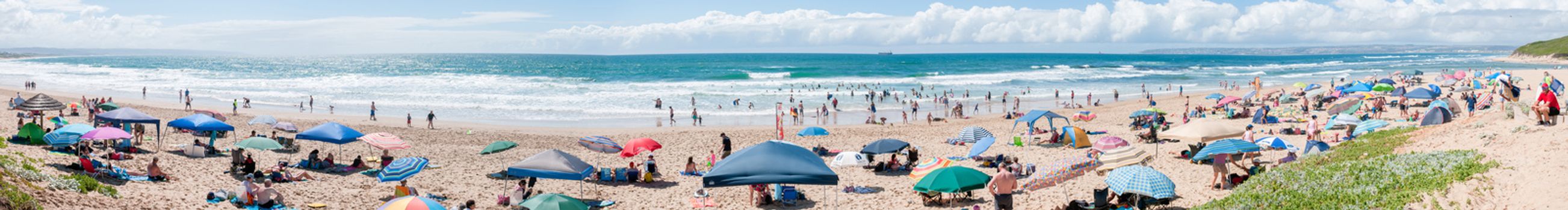 MOSSELBAY, SOUTH AFRICA - DECEMBER 29, 2014: Panorama of unidentified people at a beach in Klein Brakrivier near Mosselbay, South Africa