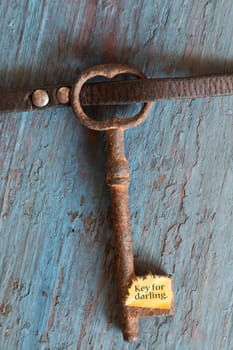 Key for darling. Concept for love, relationship, friendship and loneliness. Vintage card with old key.