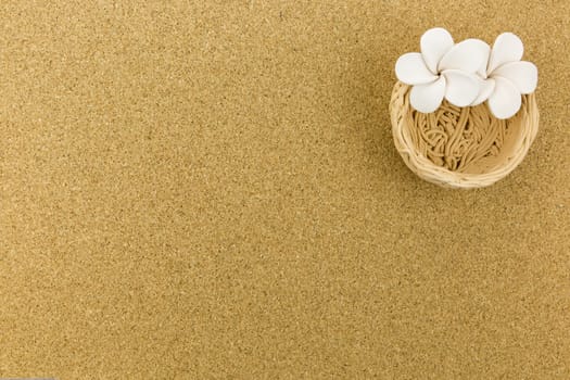 ceramic nest with flowers on cork board