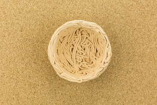 ceramic nest on cork board with paper and pencils