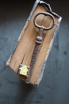 Key of house. Vintage key, old book and paper house.