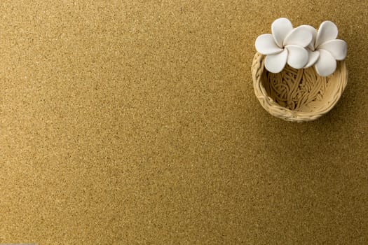 ceramic nest with flowers on cork board