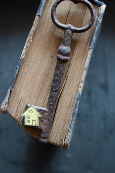 Key of house. Vintage key, old book and paper house.