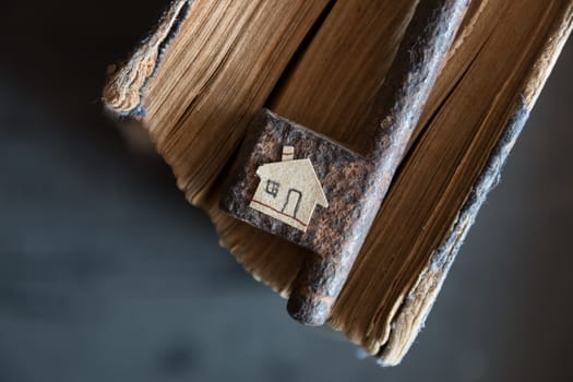 Key of house. Vintage key, old book and paper house.