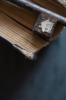 Key of house. Vintage key, old book and paper house.