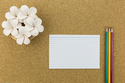 ceramic with flower and stationary on cork board