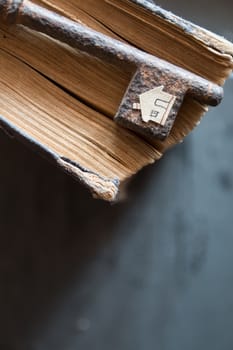 Key of house. Vintage key, old book and paper house.