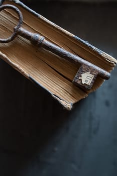 Key of house. Vintage key and old book and paper house.