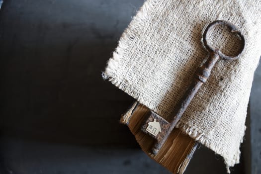 the key to the farm. Vintage key,  burlap and paper house.