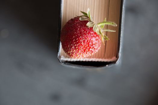 Strawberries and  cook book on a dark table. Healthy Eating.