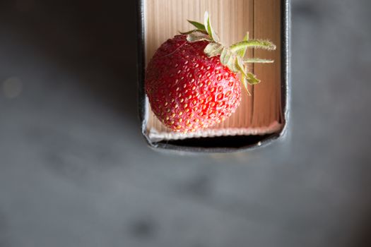 Strawberries and  cook book on a dark table. Healthy Eating.