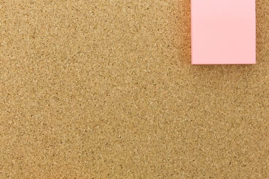 pink post it on cork board