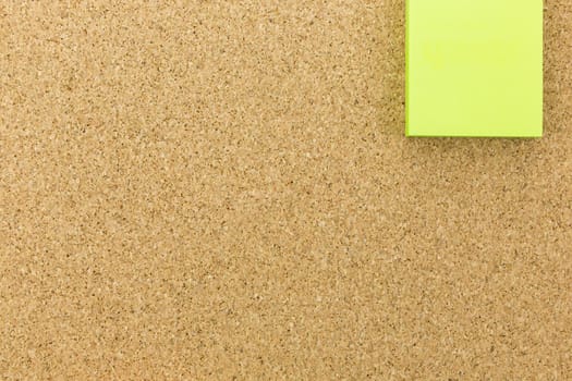 green post it on cork board