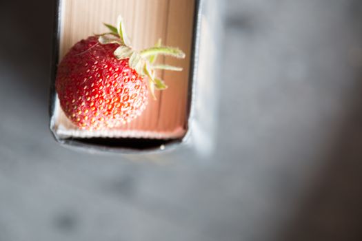 Strawberries and  cook book on a dark table. Healthy Eating. Blurred image for the background.