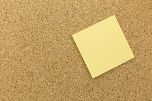 yellow post it on cork board