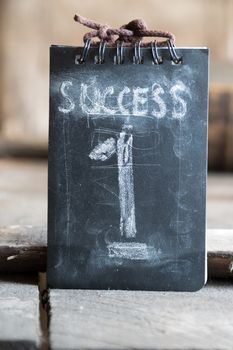 Success, first, win concept, chalk inscription and wooden table.