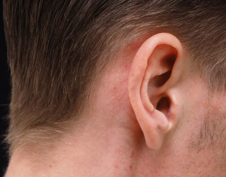 Ear of caucasian male person at closeup