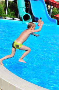 funny slim boy jumping to the pool