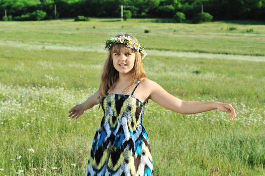 beauty dancing teen girl with garland from daisies 